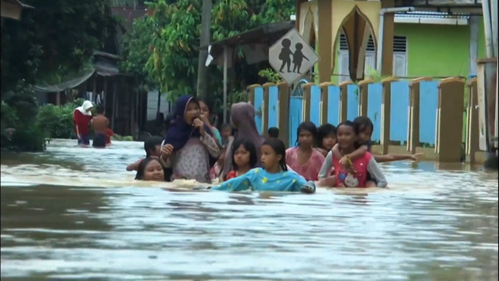 At least nine people are dead after flash floods swept through parts of Indonesia on Jan. 29. In Central Tapanuli, the streets were buried under several feet of water, forcing residents to wade through it to get around.