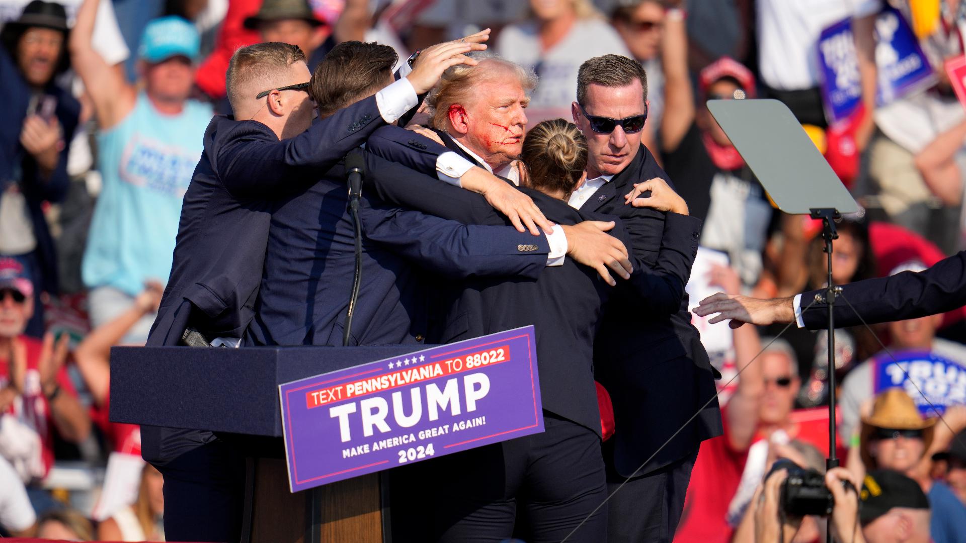 Donald Trump was whisked off the stage at a rally in Pennsylvania after apparent gunshots rang through the crowd.