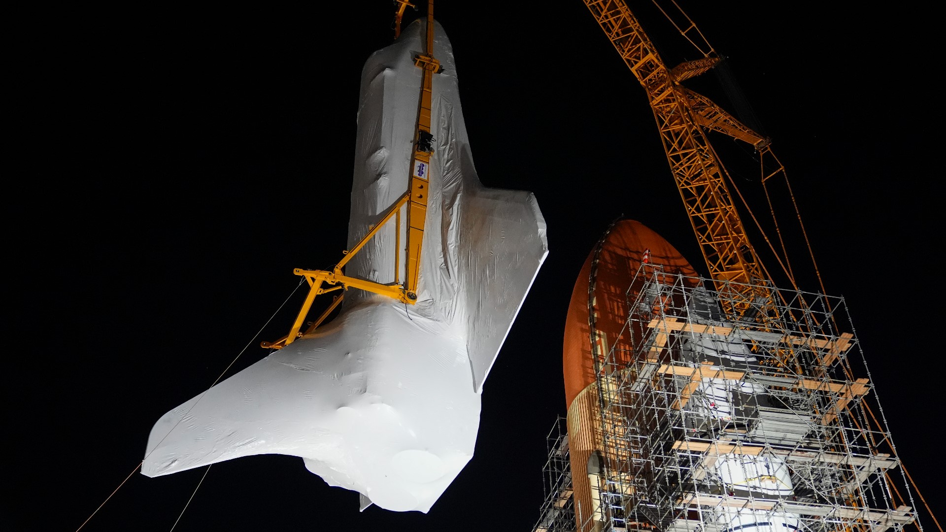 NASA's retired Space Shuttle Endeavour was carefully hoisted late Monday in Los Angeles to where it will be uniquely displayed as if it is about to blast off.