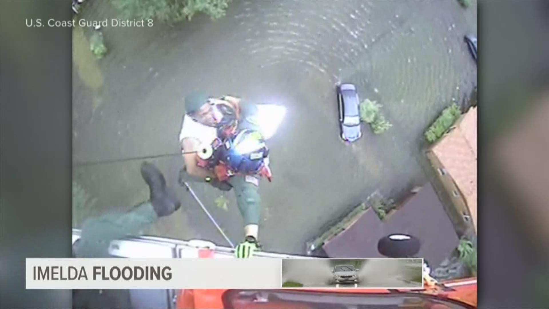 Video from the U.S. Coast Guard shows someone being hoisted into a helicopter from the flooded ground below.