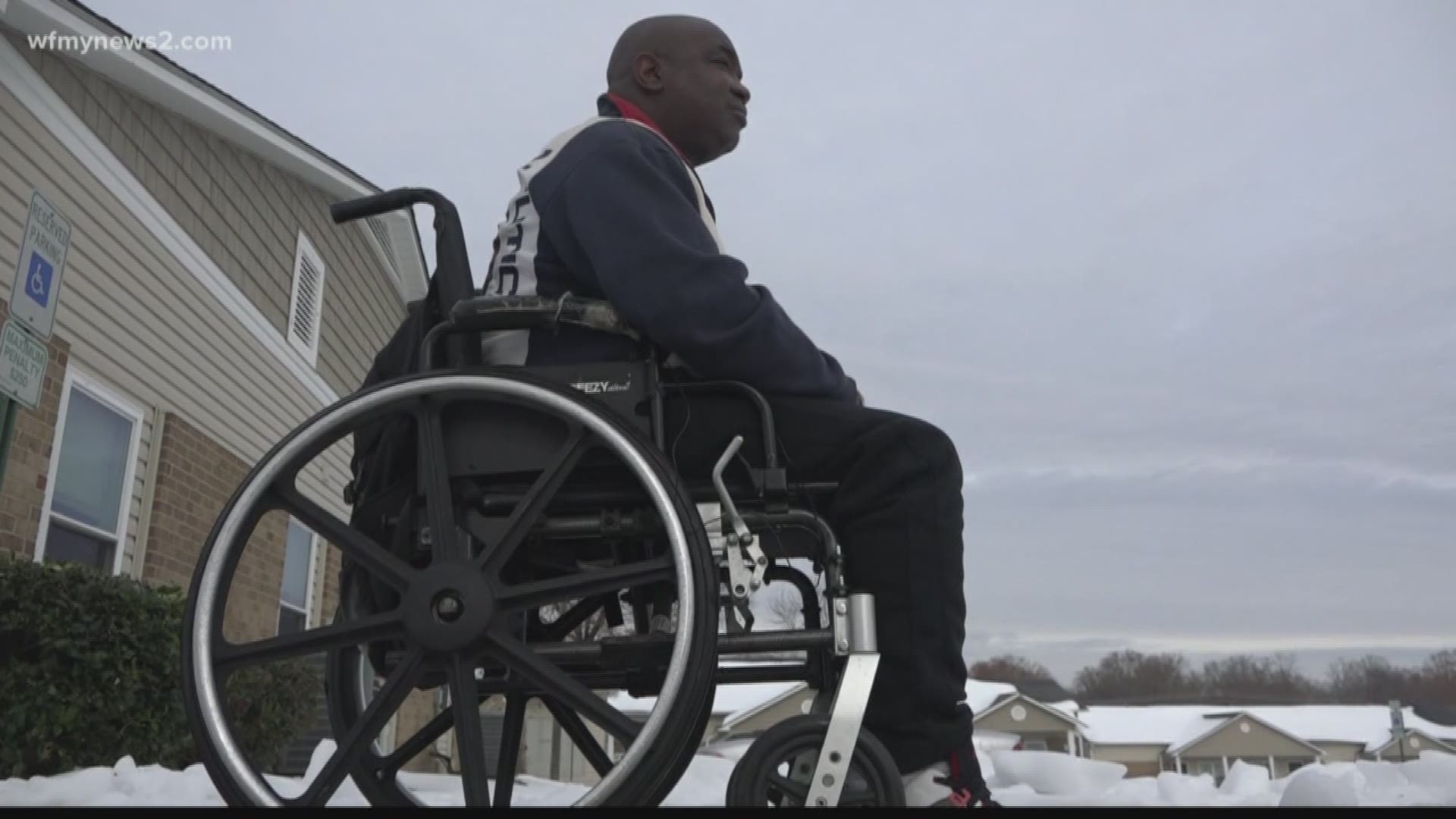 Greensboro firefighters helped a man in a wheelchair shovel snow.