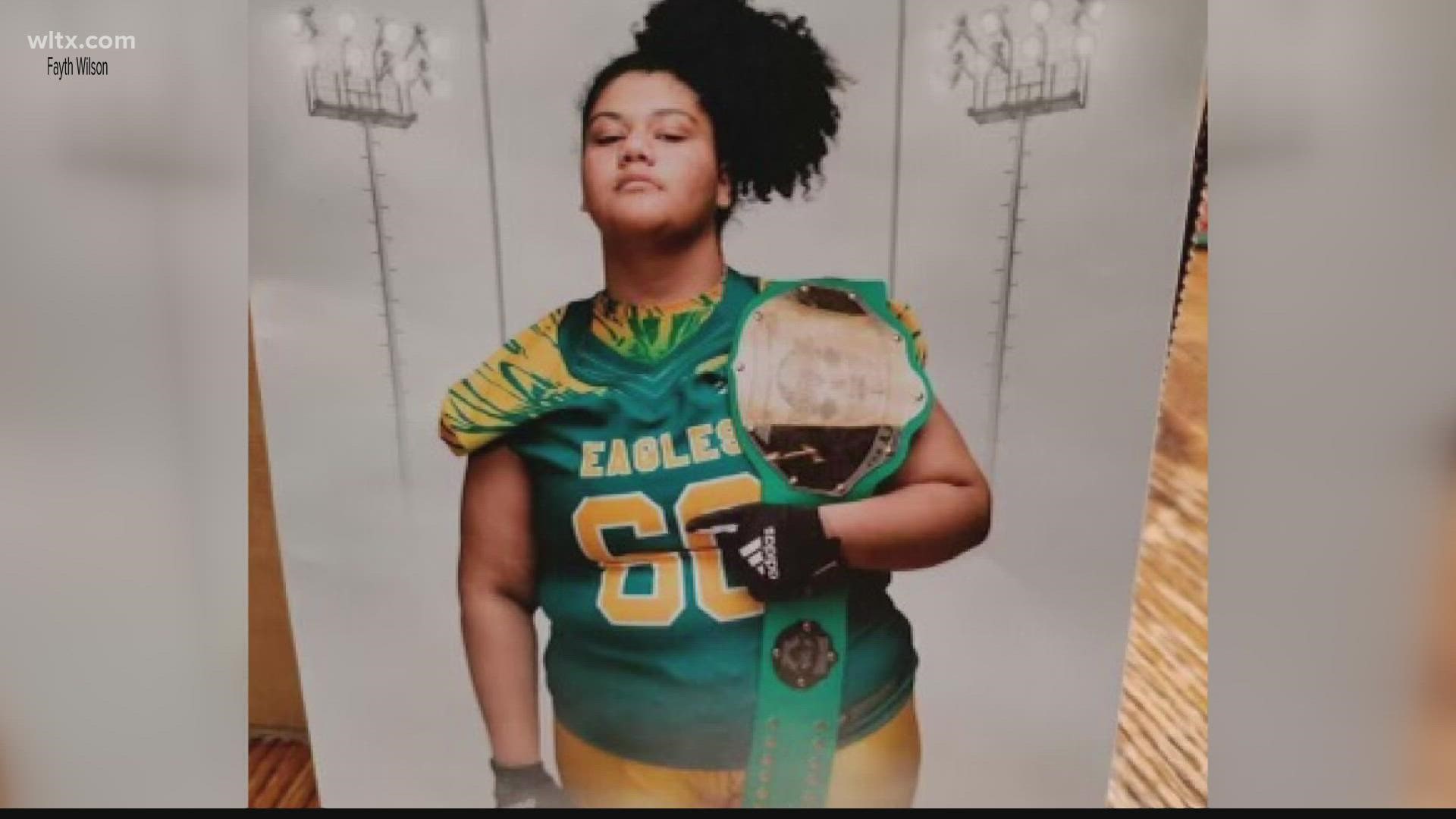 Hopkins Middle School student Lauryn Wilson has made history as the first girl to play on the school's football team and on a winning championship team.