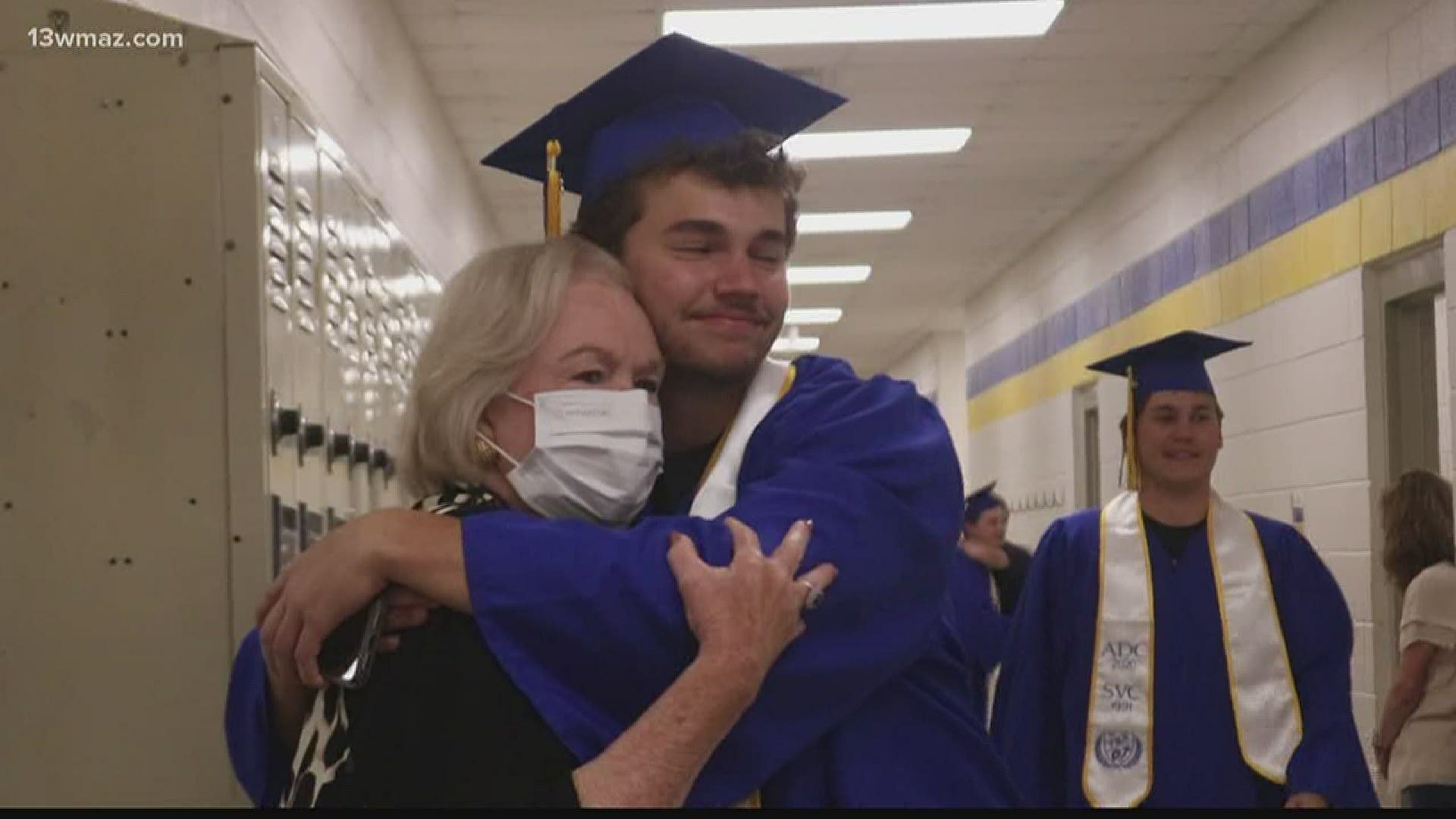 Graduating seniors at Tattnall Square Academy put on their caps and gowns to show their teachers some love