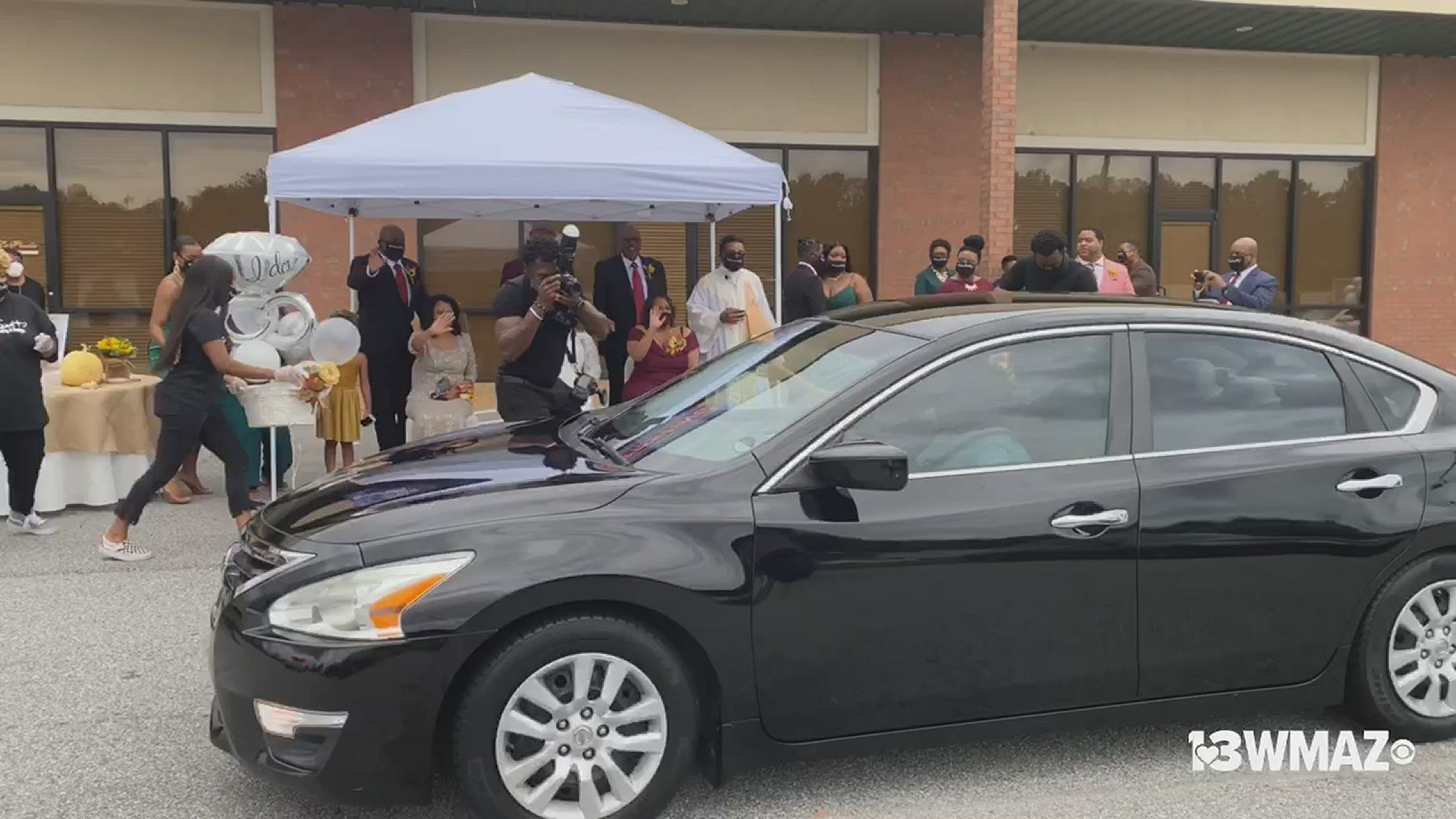 The couple says they couldn't have friends and family in the venue, but that couldn't stop them from celebrating in the parking lot.