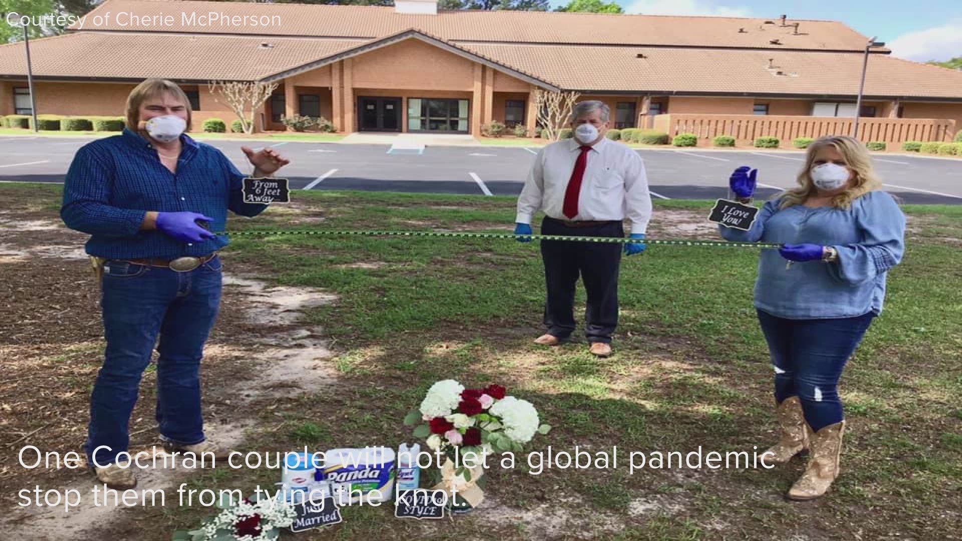 The couple exchanged vows in front of toilet paper, Lysol spray and wipes, and hand sanitizer while standing six feet apart.