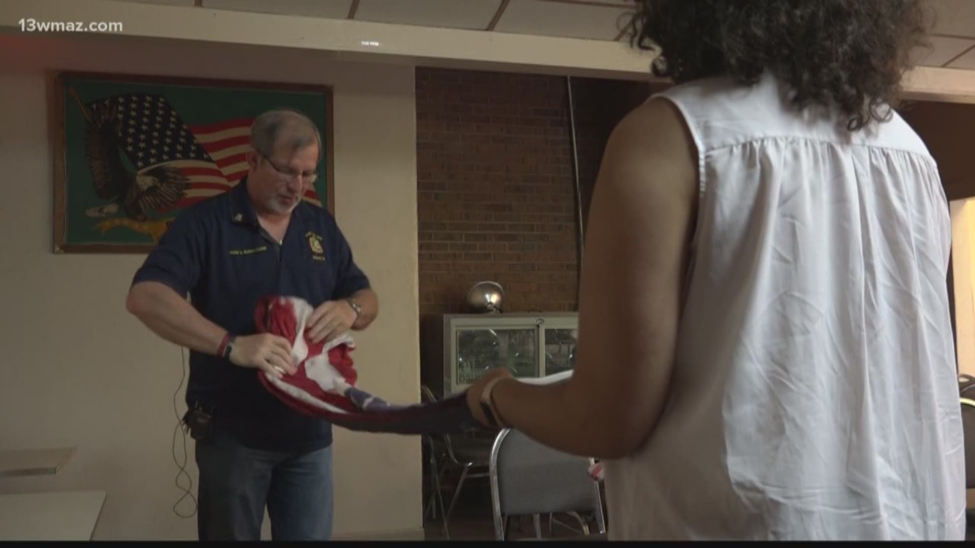 Veterans of Foreign Wars Post Commander Tracy Burkholder shows us how to properly fold a flag.