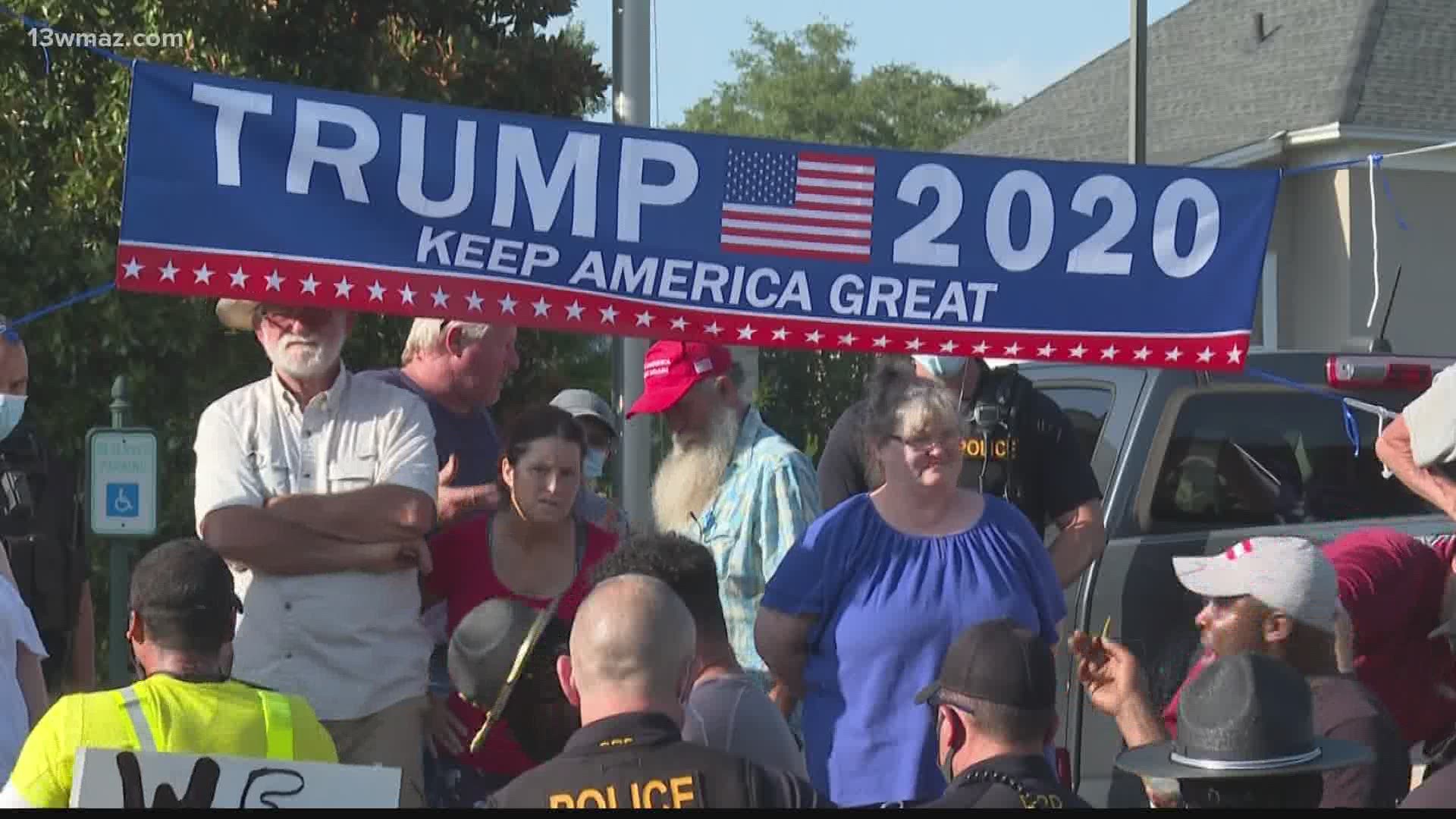 Many gathered downtown, some waving flags in support of President Trump, others protesting the  Confederate monument with signs saying "Black Lives Matter"