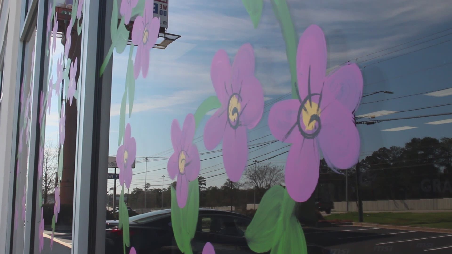 As Macon gets into Cherry Blossom Festival season, we were 'just curious' about who paints the murals of cherry blossoms on buildings and cars.
