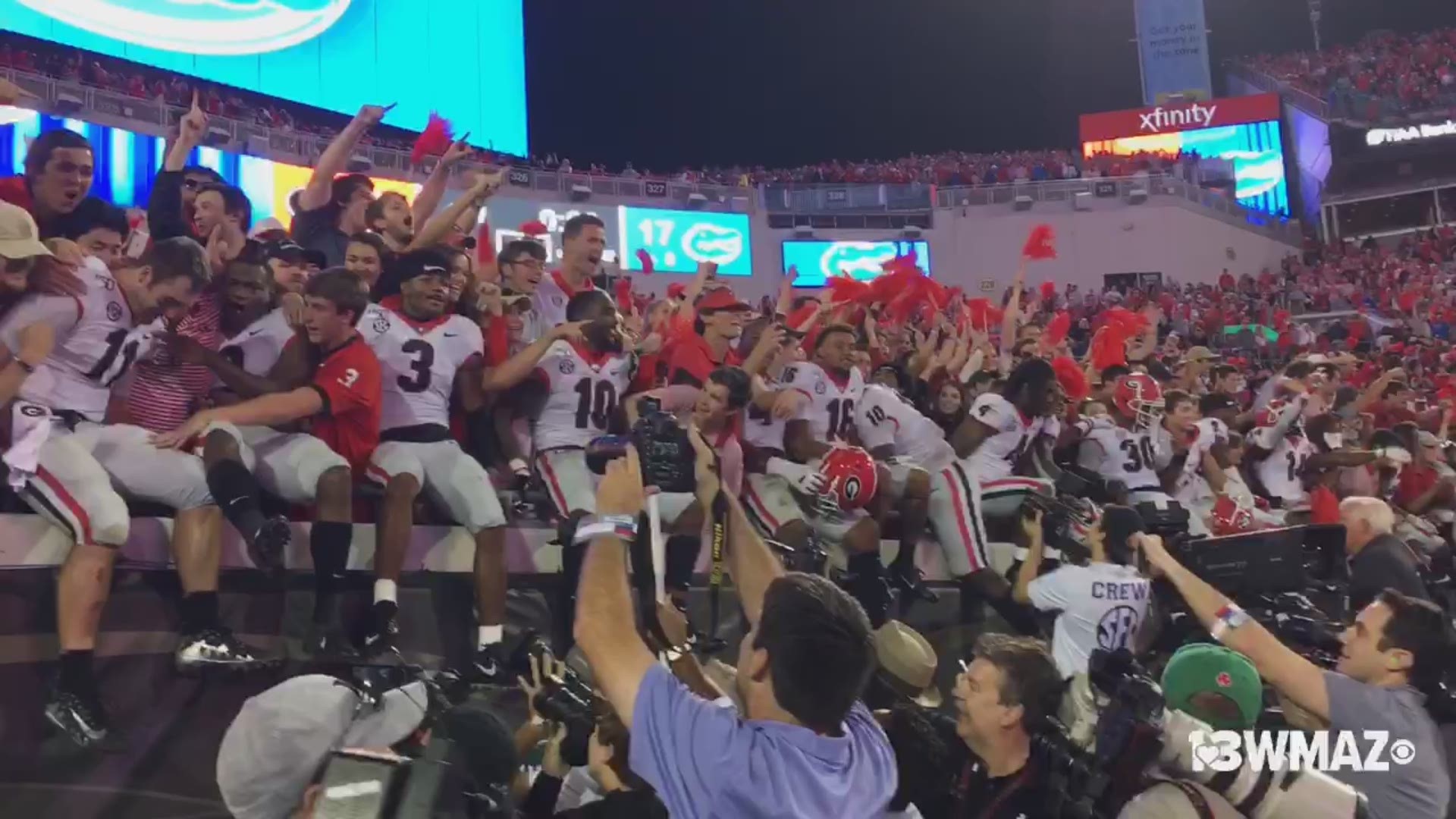 Georgia Bulldogs, including local players Jake Fromm, Travon Walker, Malik Herring and Kearis Jackson celebrate with fans after beating rival, Florida, 24-17.