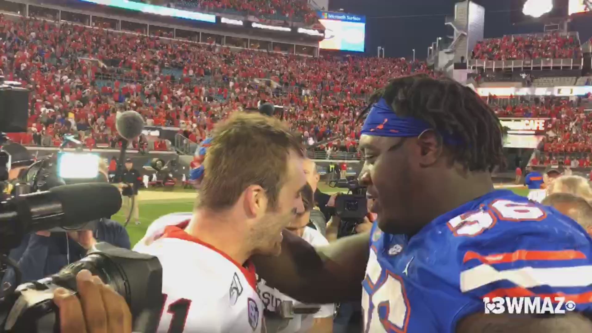 Fromm shakes hands with Florida players and prays with his teammates after a big win.