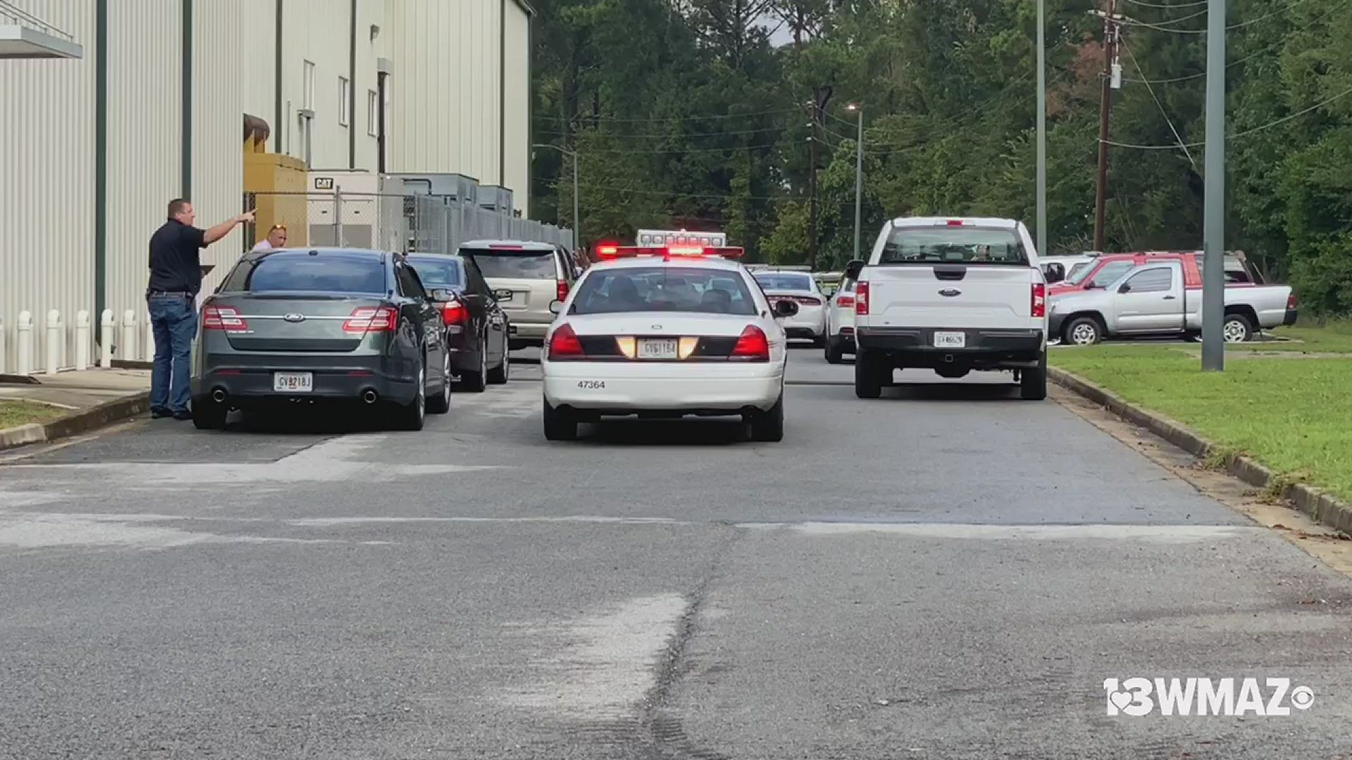 The Bibb County Coroner's Office is on the scene after a report of a body found behind a Bibb Schools administrative building.