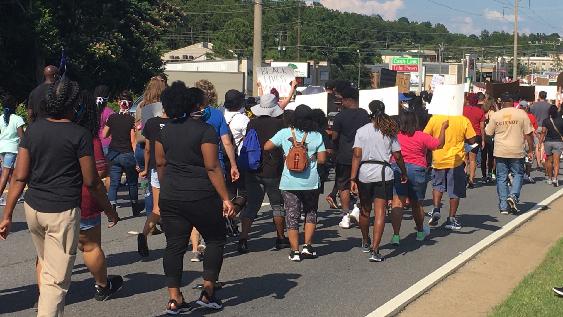 The protest led by the Houston County Branch of the NAACP, started in the parking lot of the At Home store and ended at Warner Robins City Hall.