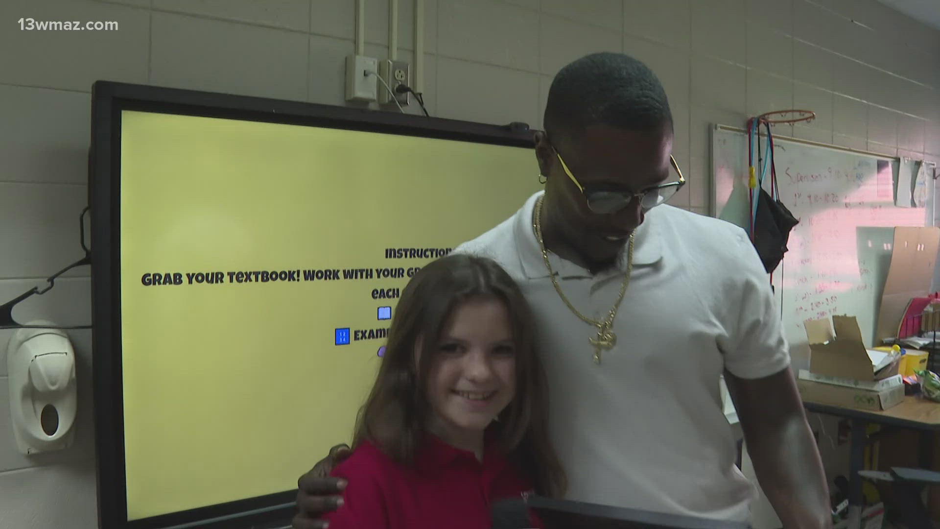 Junior Journalist Cora Jean Daniel surprised Mr. Bridges at Ballard-Hudson Middle, announcing him as "My Teacher is Tops" winner.