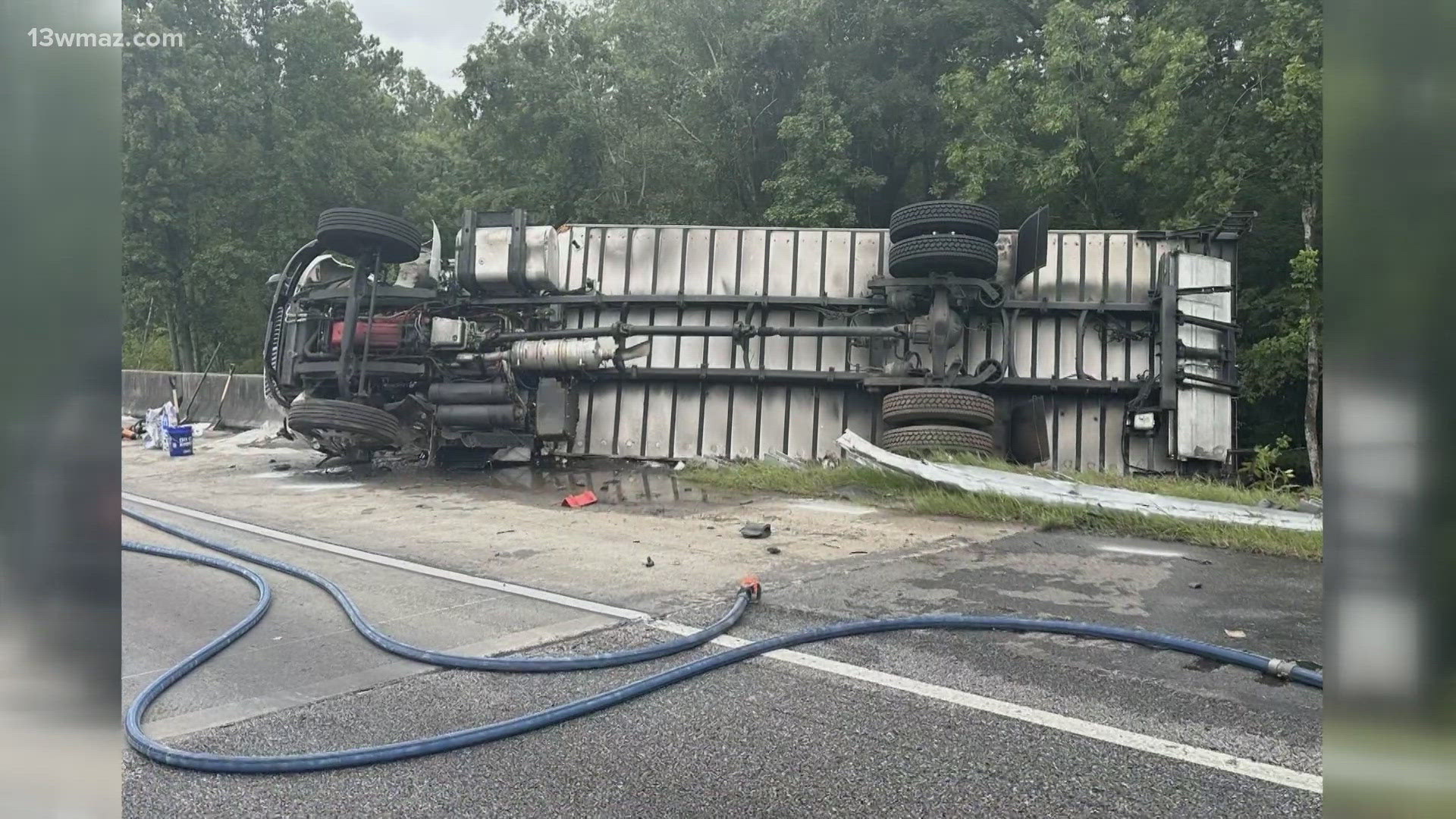 The semi truck hit a guardrail and flipped onto the passengers side. The driver was brought to a hospital with injuries, while the passenger died