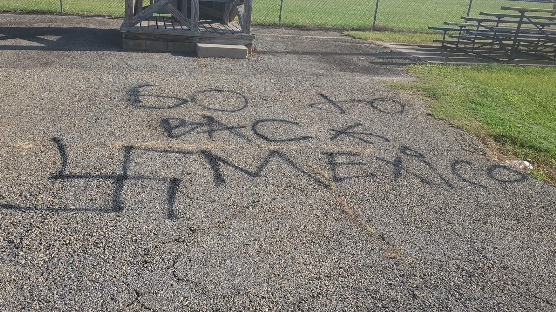 The spray painted words in the park read 'Go back to Mexico' along with a swastika.