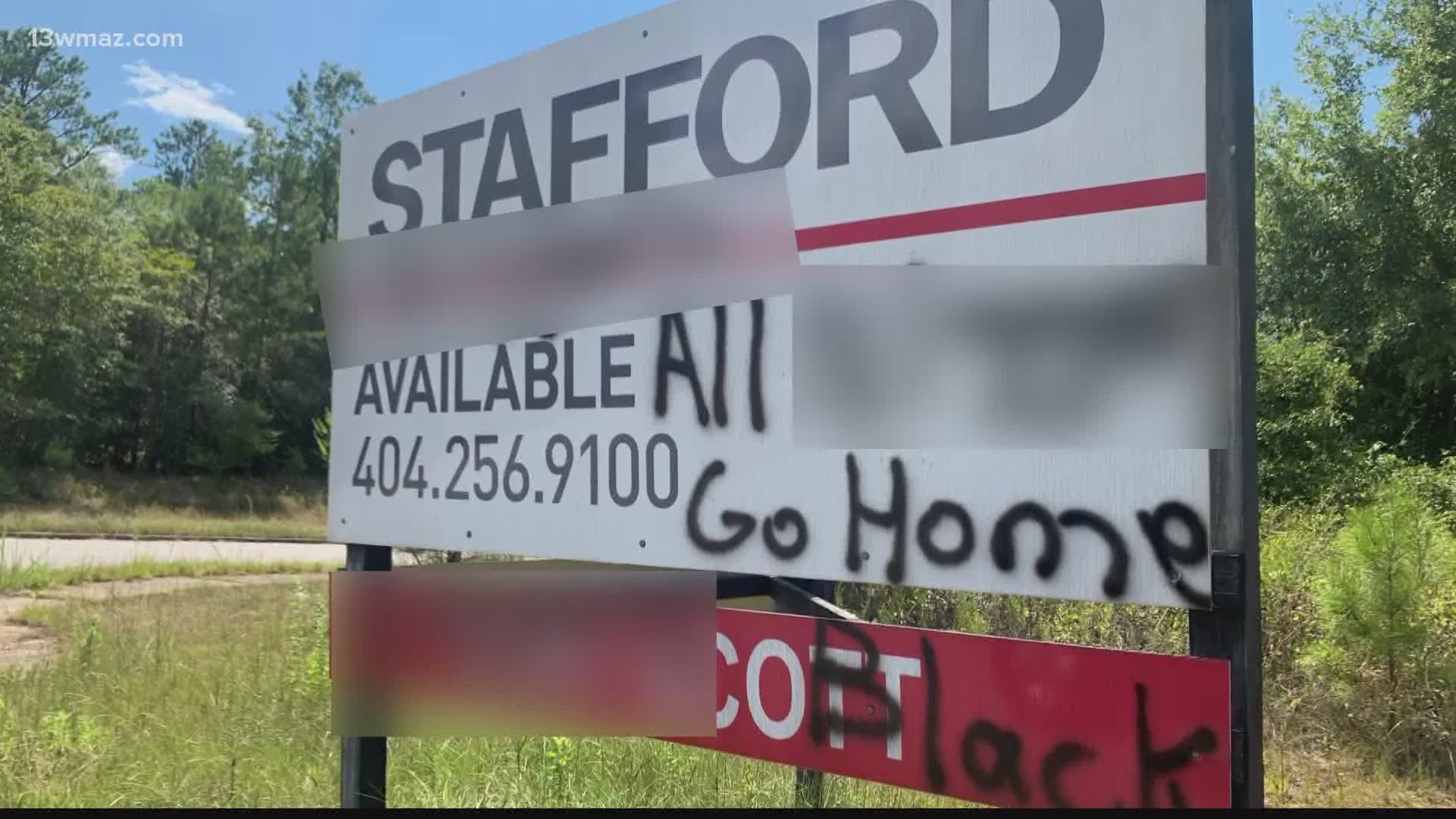 Bibb County investigators are looking for a person who vandalized signs near an African-American business in west Macon over the weekend.