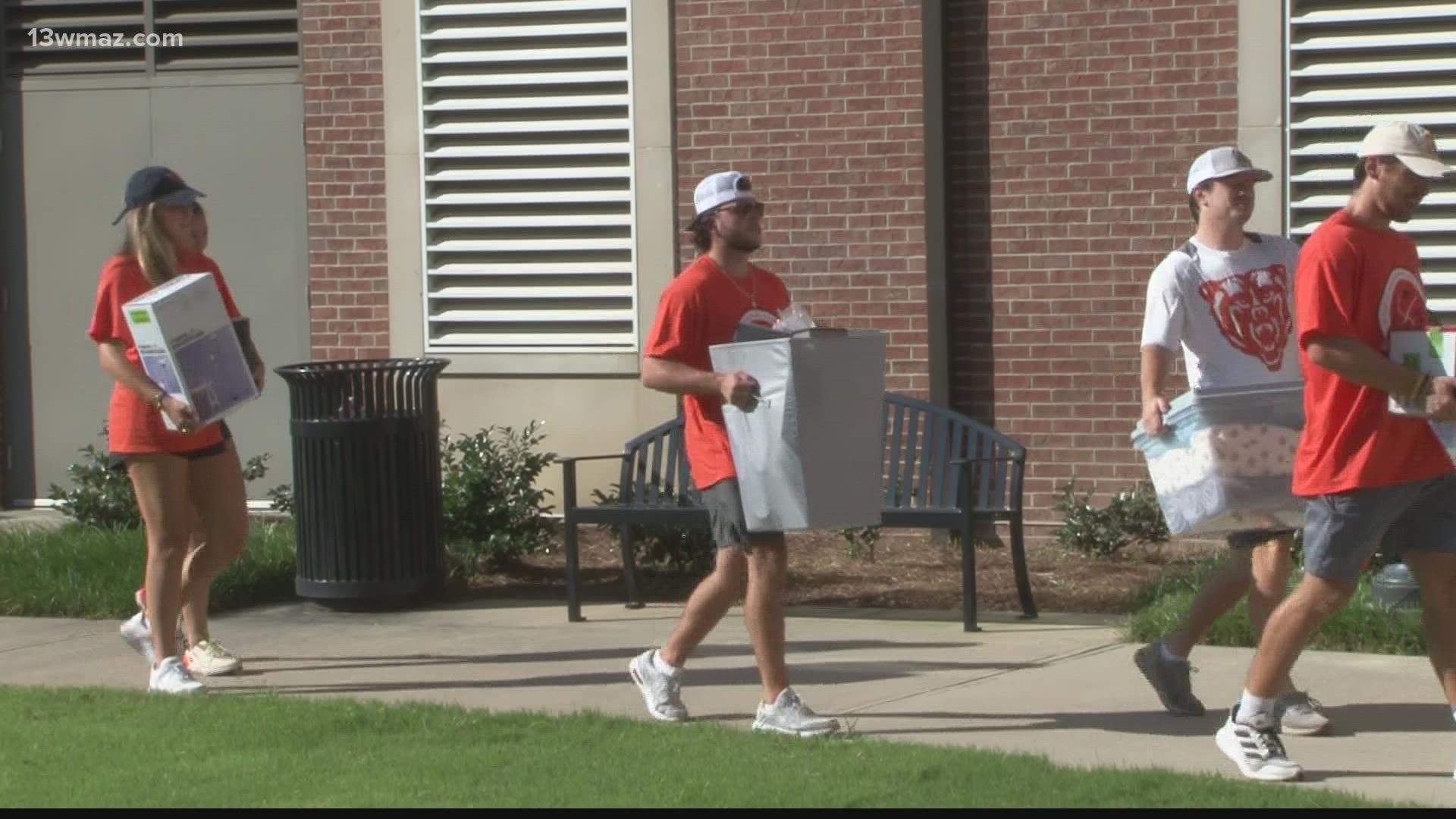 Hundreds of people gathered in front of the dorms to unpack their vehicles as students prepare to start the school year next week