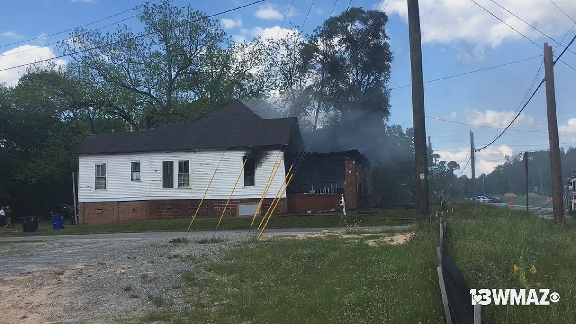 Several fire trucks are at the scene of an active house fire on Millerfield Road in Macon.