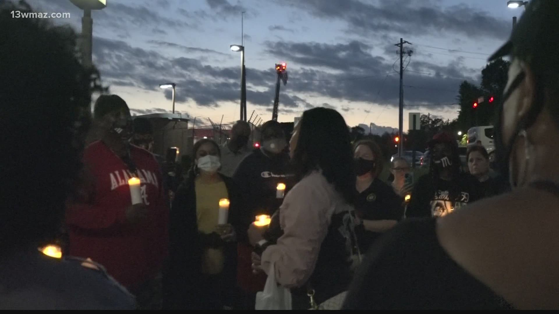 The family and colleagues of Christopher Knight gathered in front of the Bibb Sheriff's Office for a candlelight vigil to remember the fallen deputy.