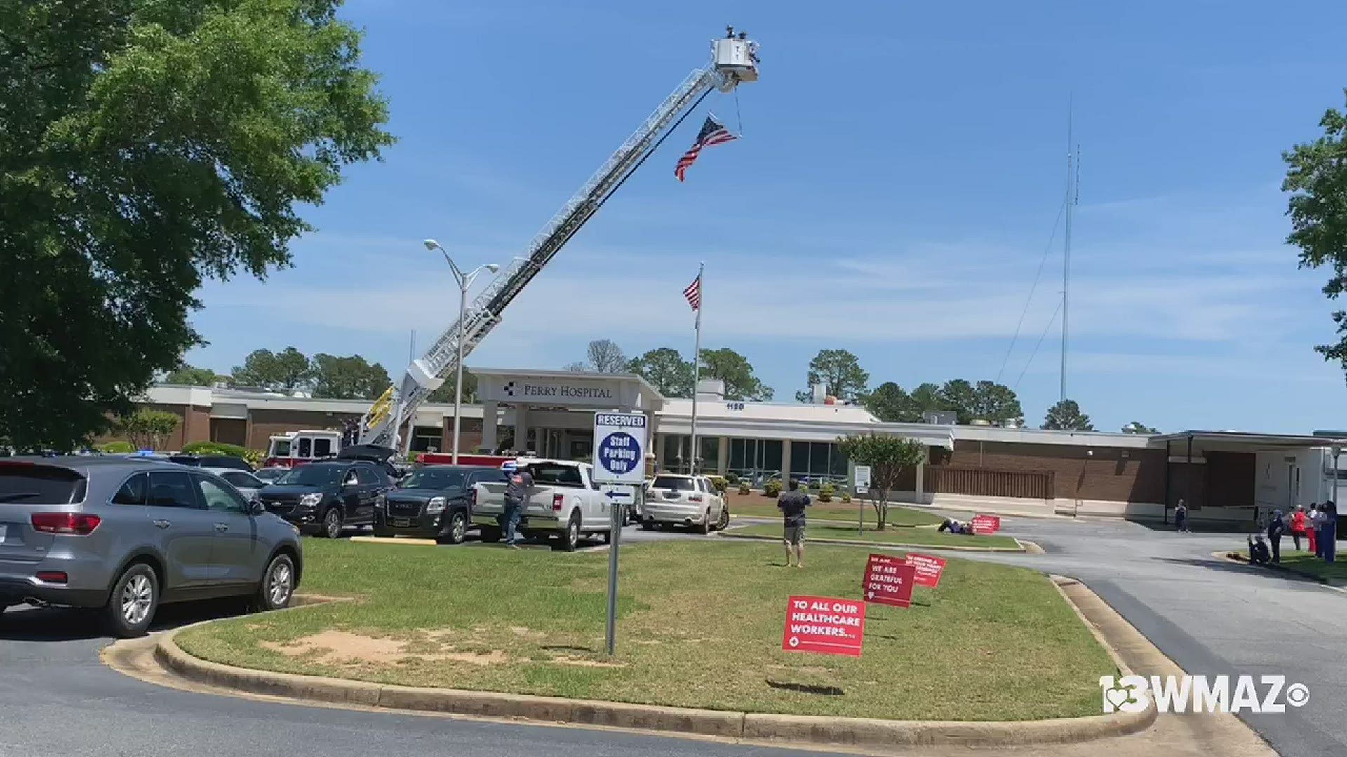 The fire department raised the American flag and healthcare workers gathered outside the hospital.