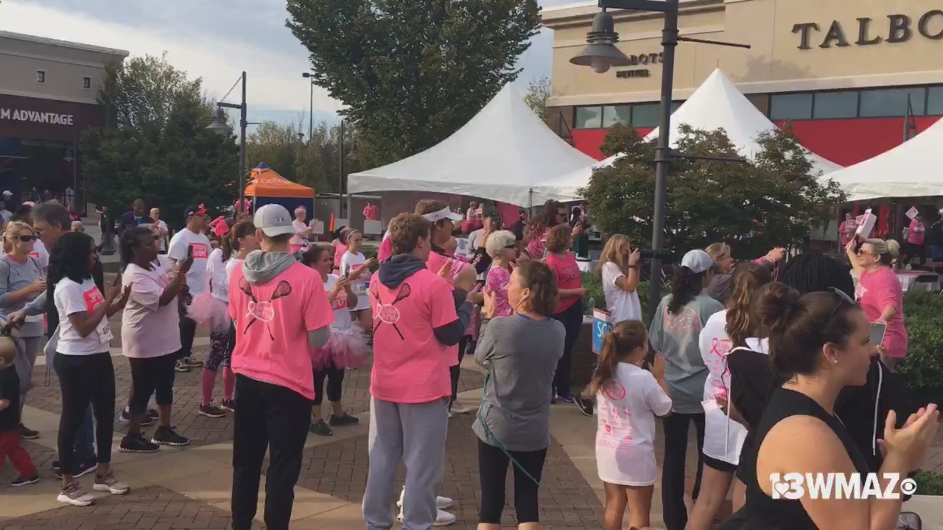 Survivor Ceremony at United in Pink 5K at Shoppes at River Crossing. Breast cancer survivors honored by United in Pink organization. They provide support for breast cancer patients and their families.