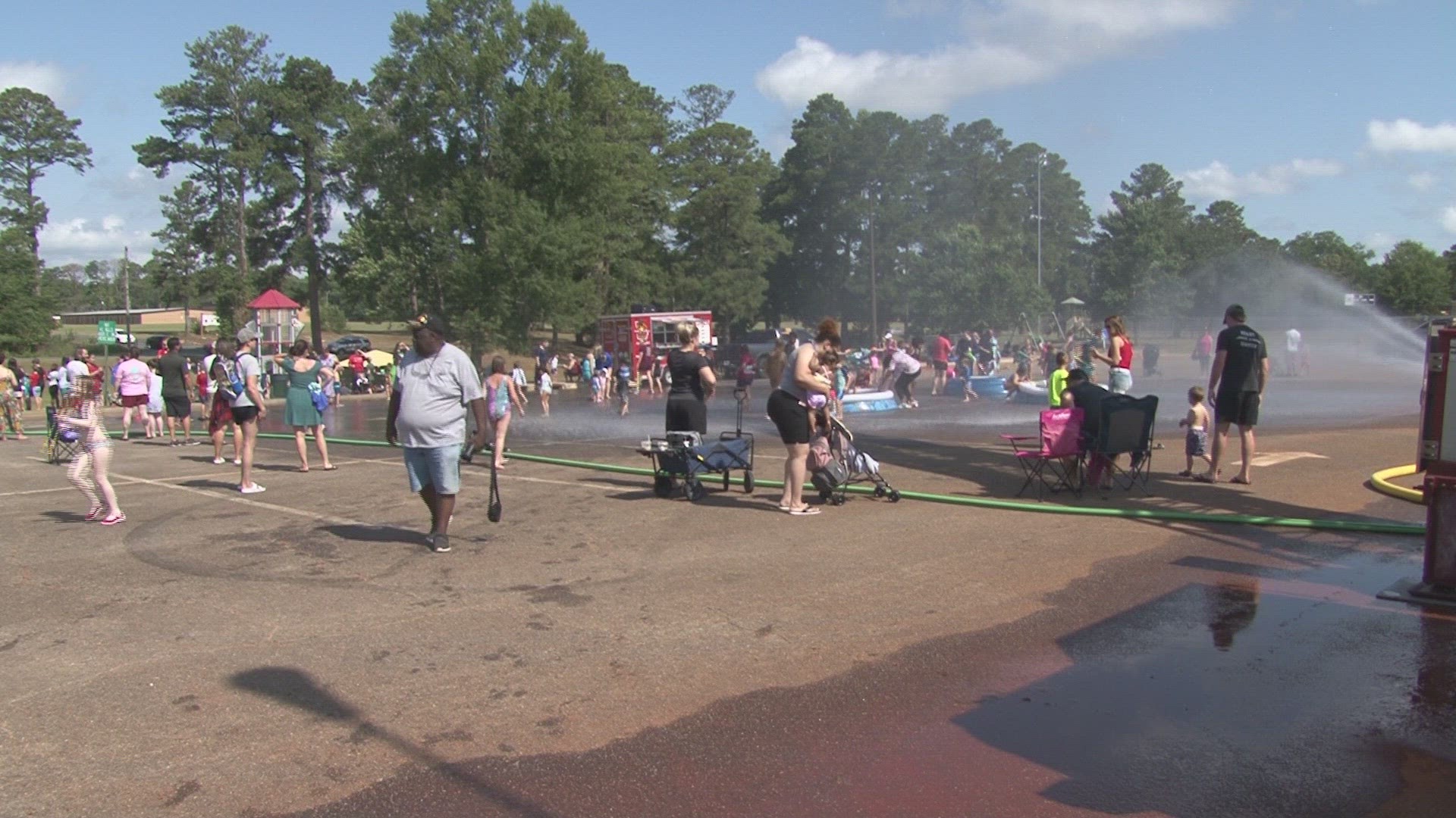 The event featured dueling firetrucks that sprayed water to keep the community cool.