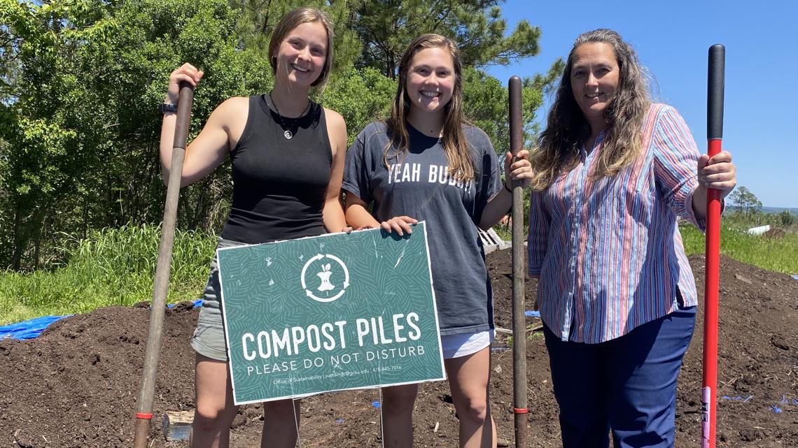 College students saving environment by composting waste