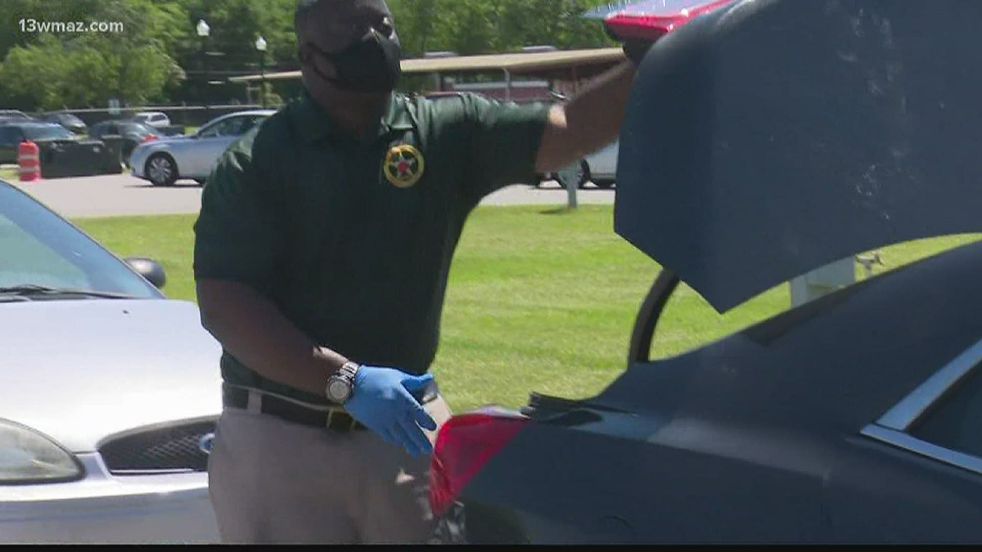 The Peach County Sheriff's Office asked everyone to stay in their car and have their trunk clear, so they could load food in the back.