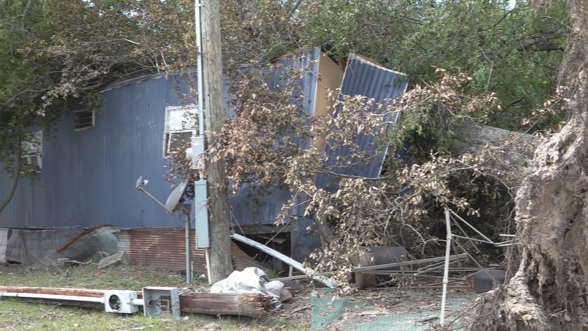 One neighbor says a tree fell onto a home, but it still hasn't been picked up