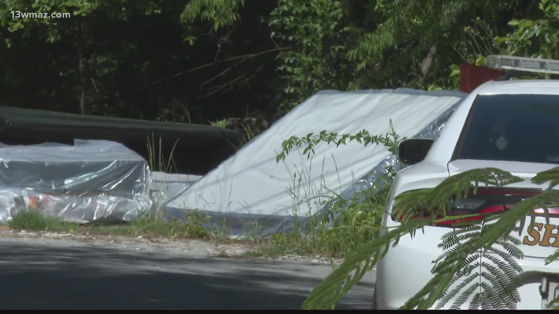 A man walking on his normal route in the neighborhood saw an arm sticking out from under a mattress and called 911