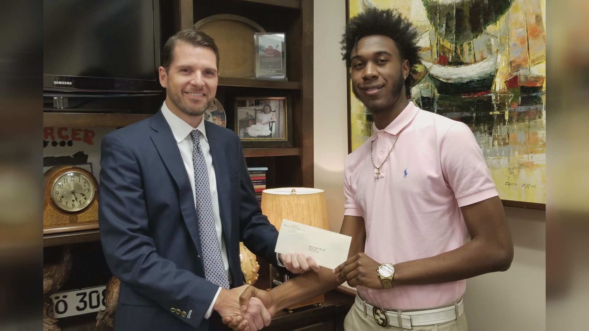 The Buzzell, Welsh and Hill law firm awarded Adrian Thomas, Jr. $2500 for his essay on a new driving law that could help teens behind the wheel