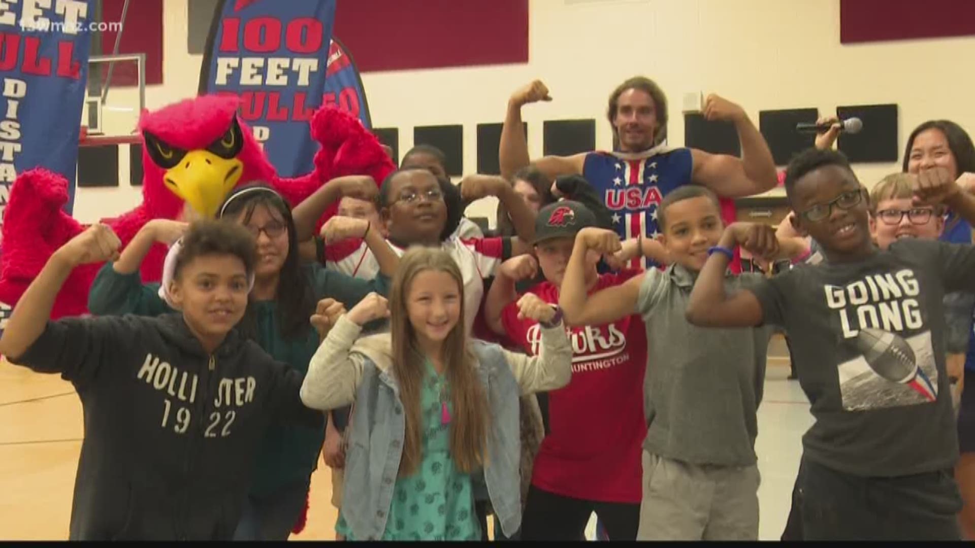 Before Mark Kirsch does the impossible by pulling a 100,000-pound C-130 plane this weekend, he swung by Huntington Middle School to speak with students.