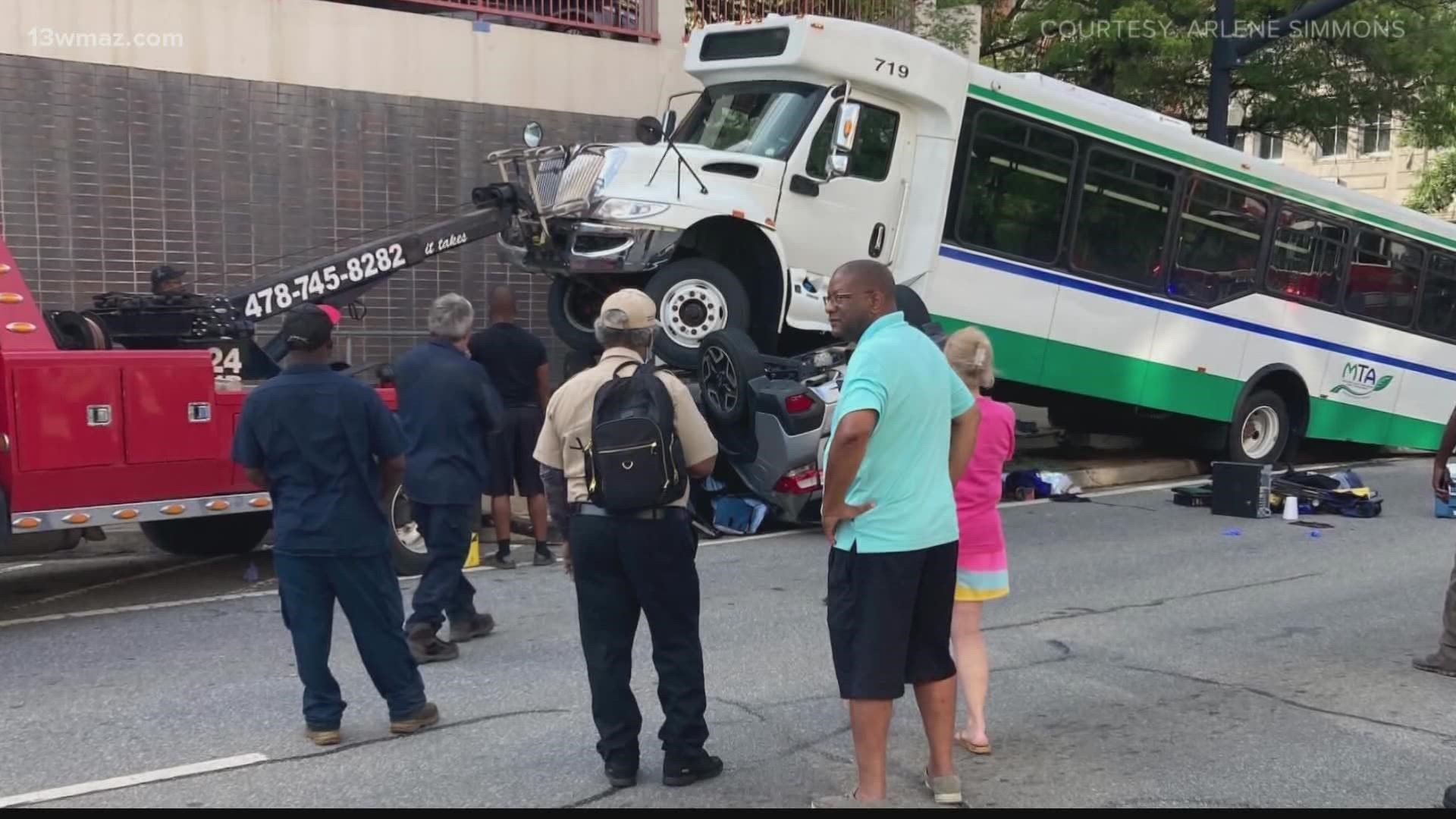 People in Macon are calling an off-duty firefighter a hero after a Macon Transit bus crashed and landed on top of a car in downtown Macon.