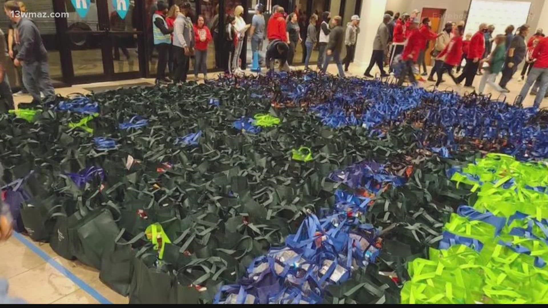 Families drove up and volunteers put a turkey, along with boxes of other food, in each car.