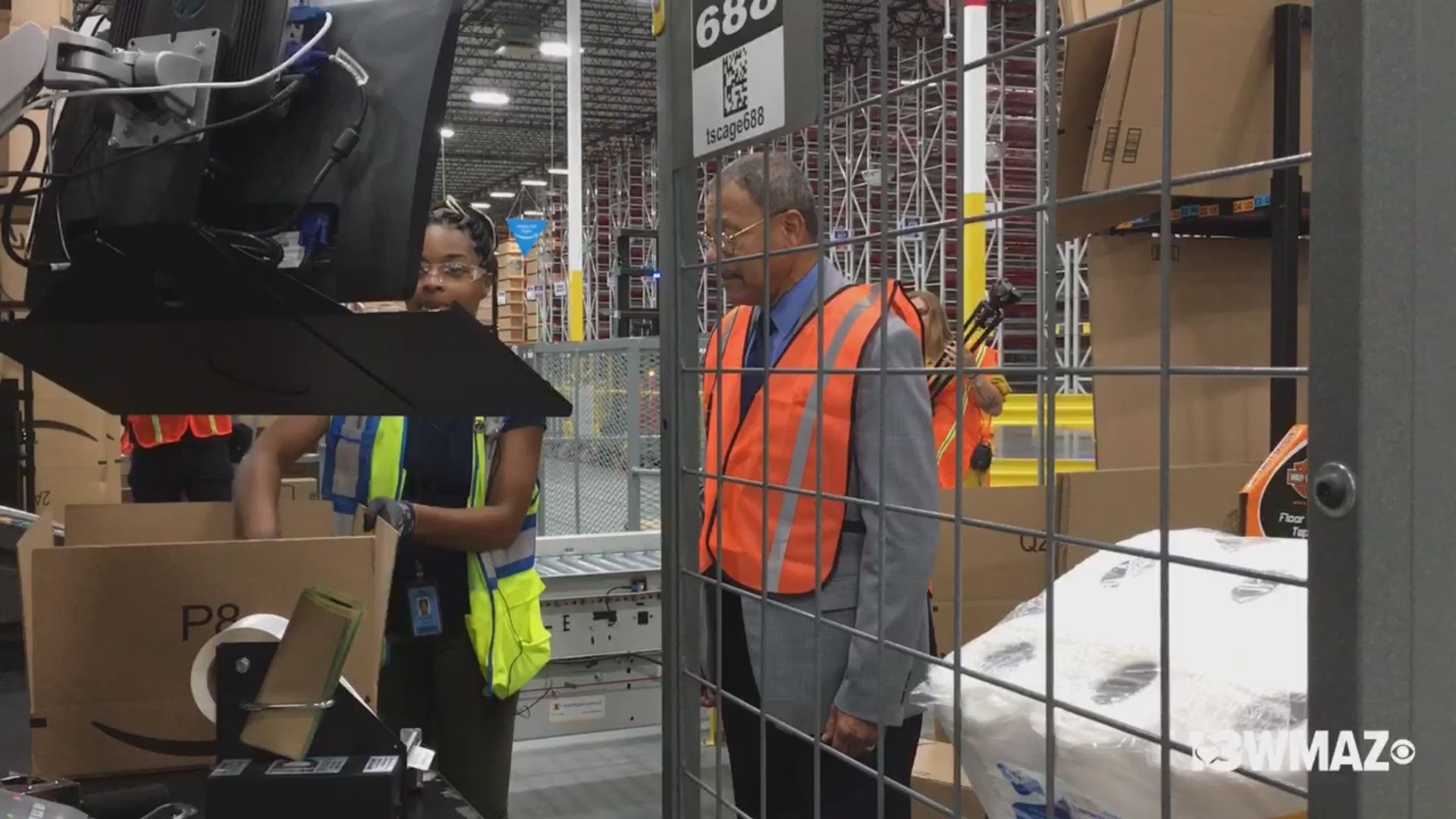After months of waiting, the new Amazon fulfillment center has opened in south Bibb County. Here Congressman Bishop is taught by an employee on how to pack an Amazon box for shipping.
