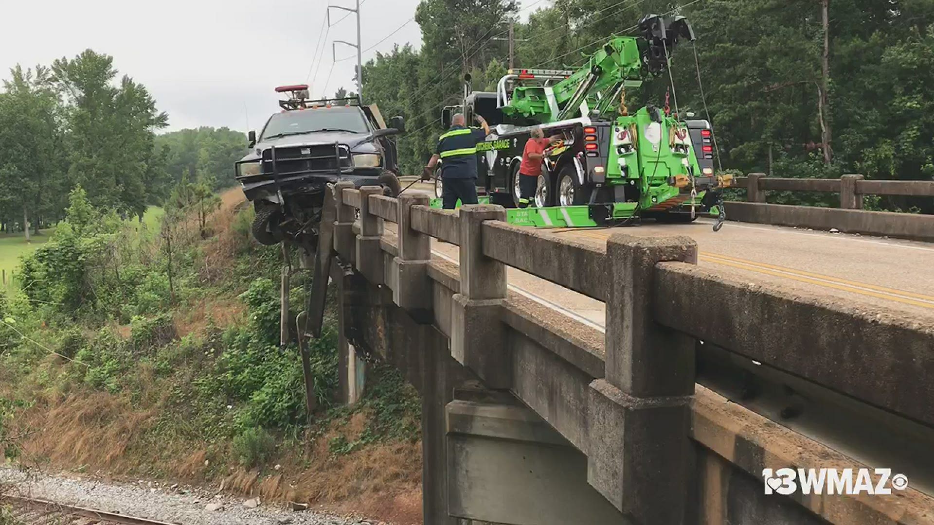 A work truck ran off through the Bass Road railroad bridge between Rivoli Drive and Forsyth Road.