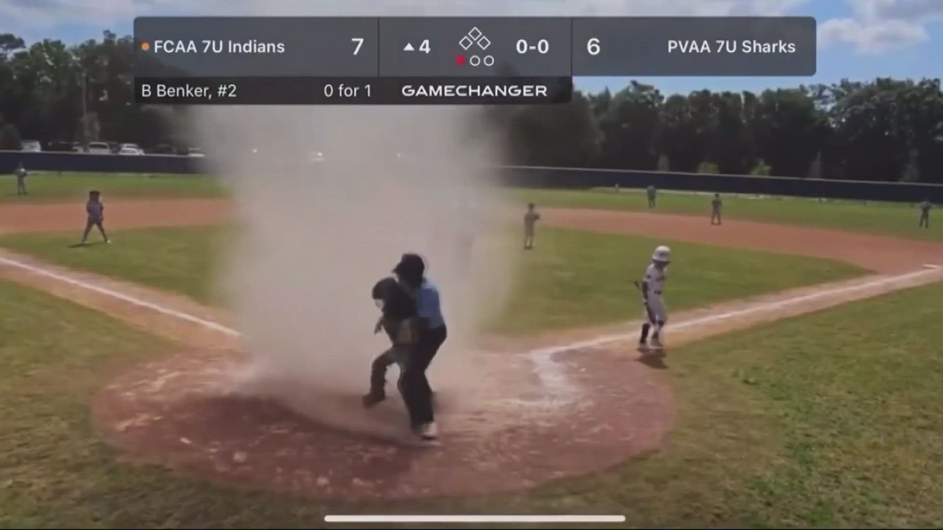 The teen umpire managed to battle the wind to save the catcher who was trapped in the dust devil in Jacksonville.
