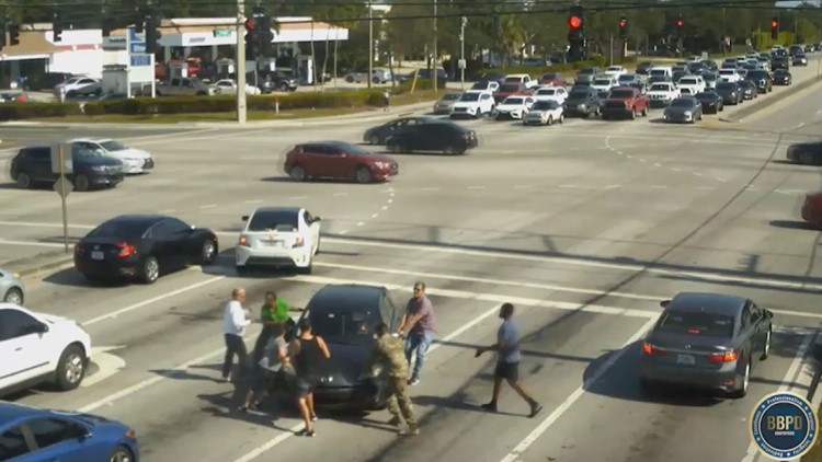 Watch as good Samaritans help stop car as driver suffers medical issue