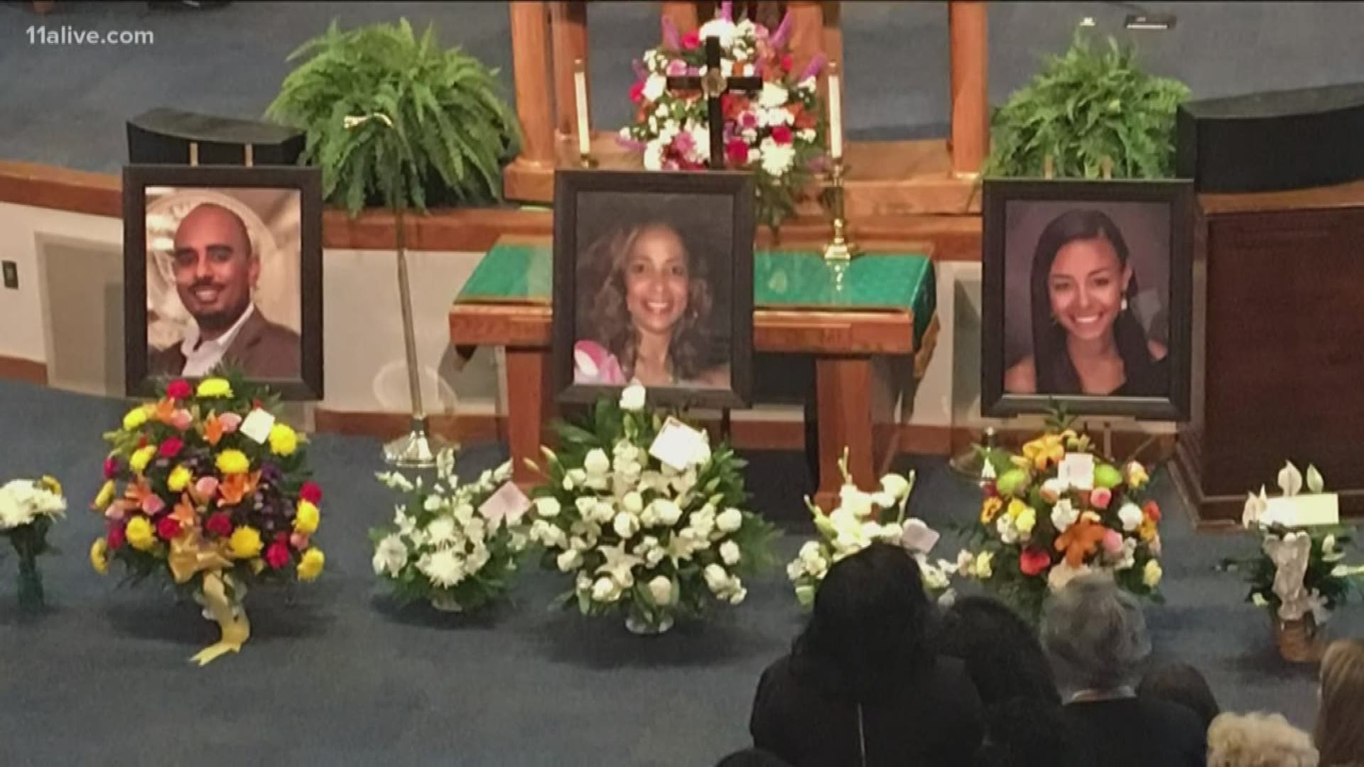 There were no caskets - just three large framed photos at the altar. The church and parking lot were overflowing. Easily several hundred people were there.