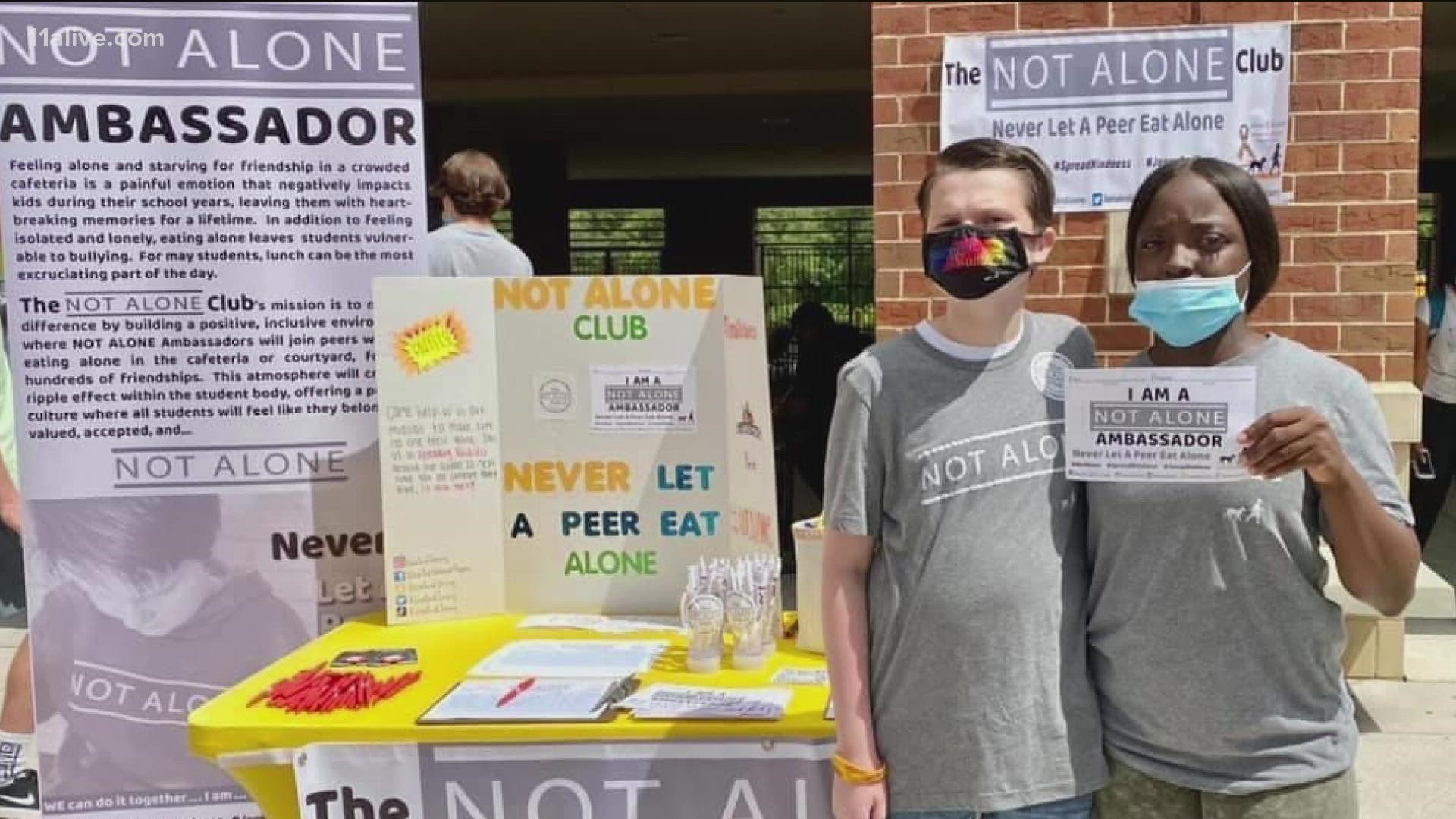 After a custodian sat with a 10th grader with autism at Johns Creek High School, the pair is now teaming up to make sure no student has to eat lunch alone.