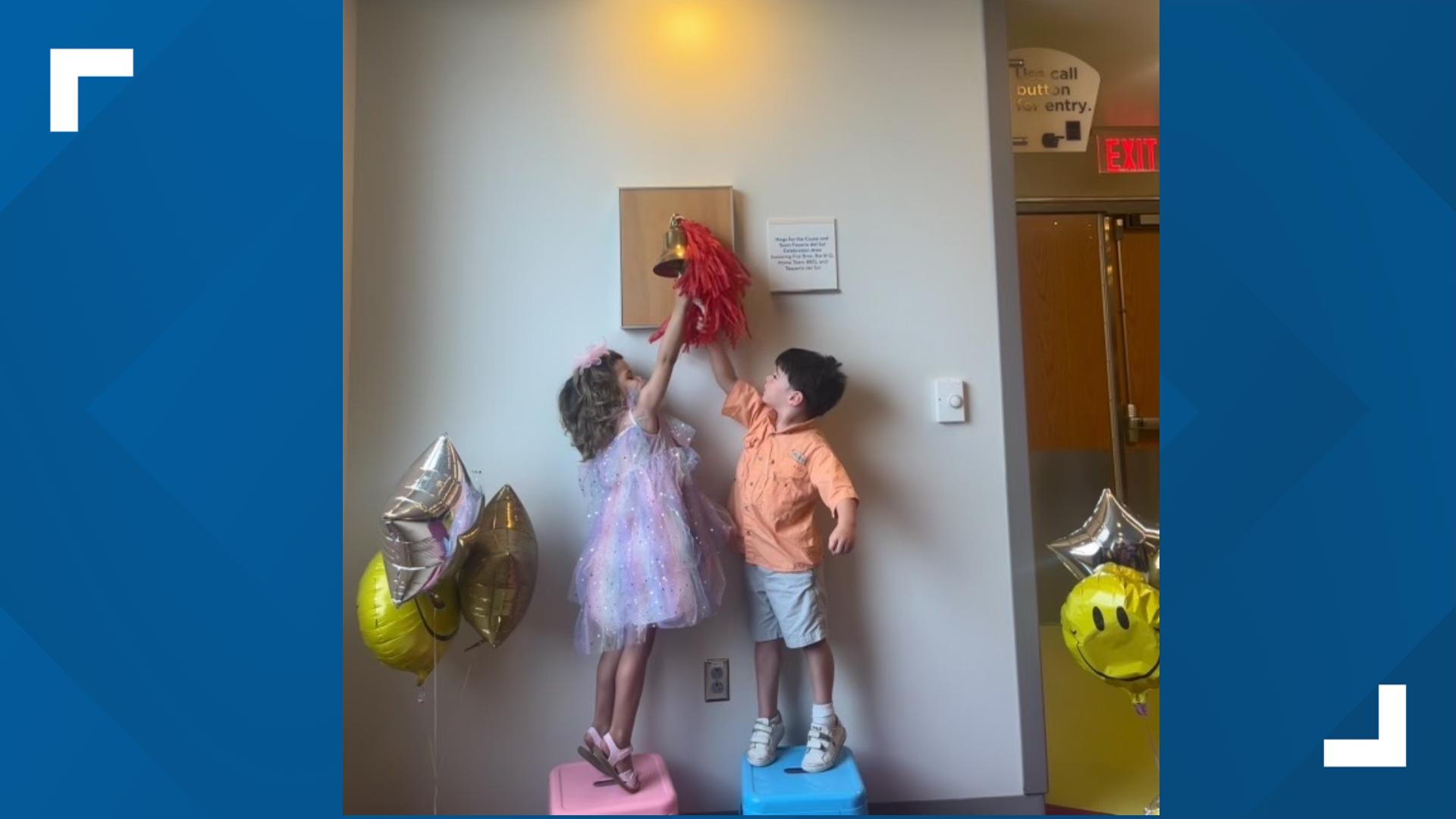 Toddlers Elena and Nash rang the bell after 855 days of treatment for cancer.